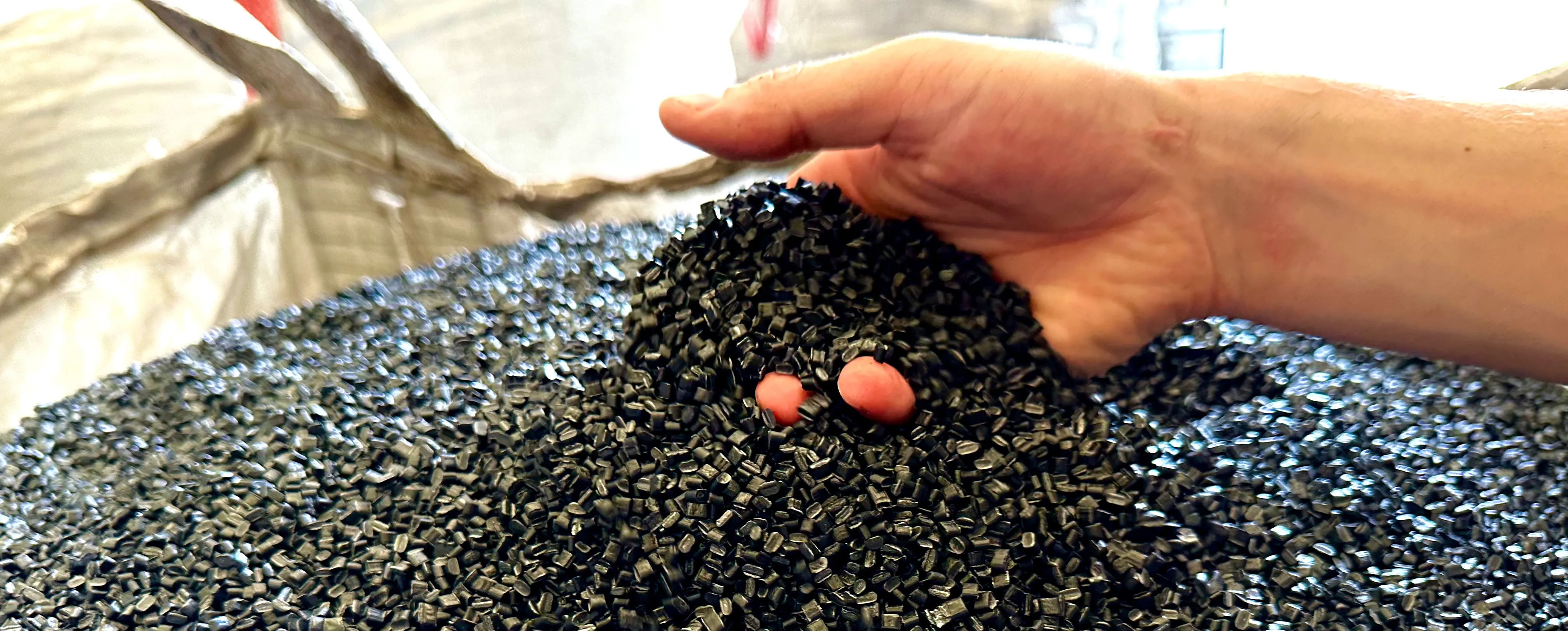 Hands with plastic pellets img